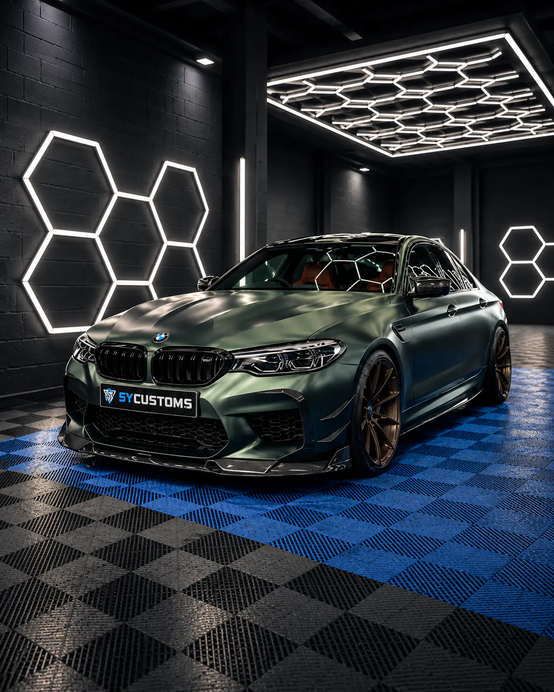 SY CUSTOMS workshop with a BMW M5 on the shop floor